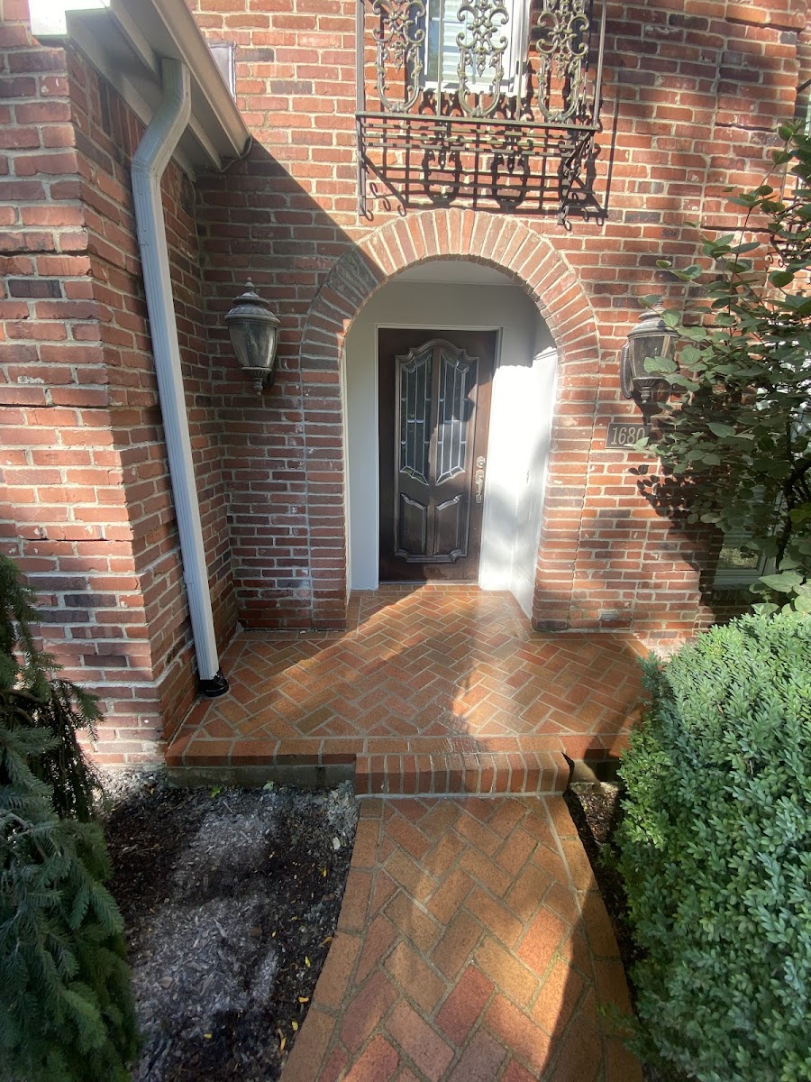 Herringbone brick walkway and archway installed by Ewing Concrete